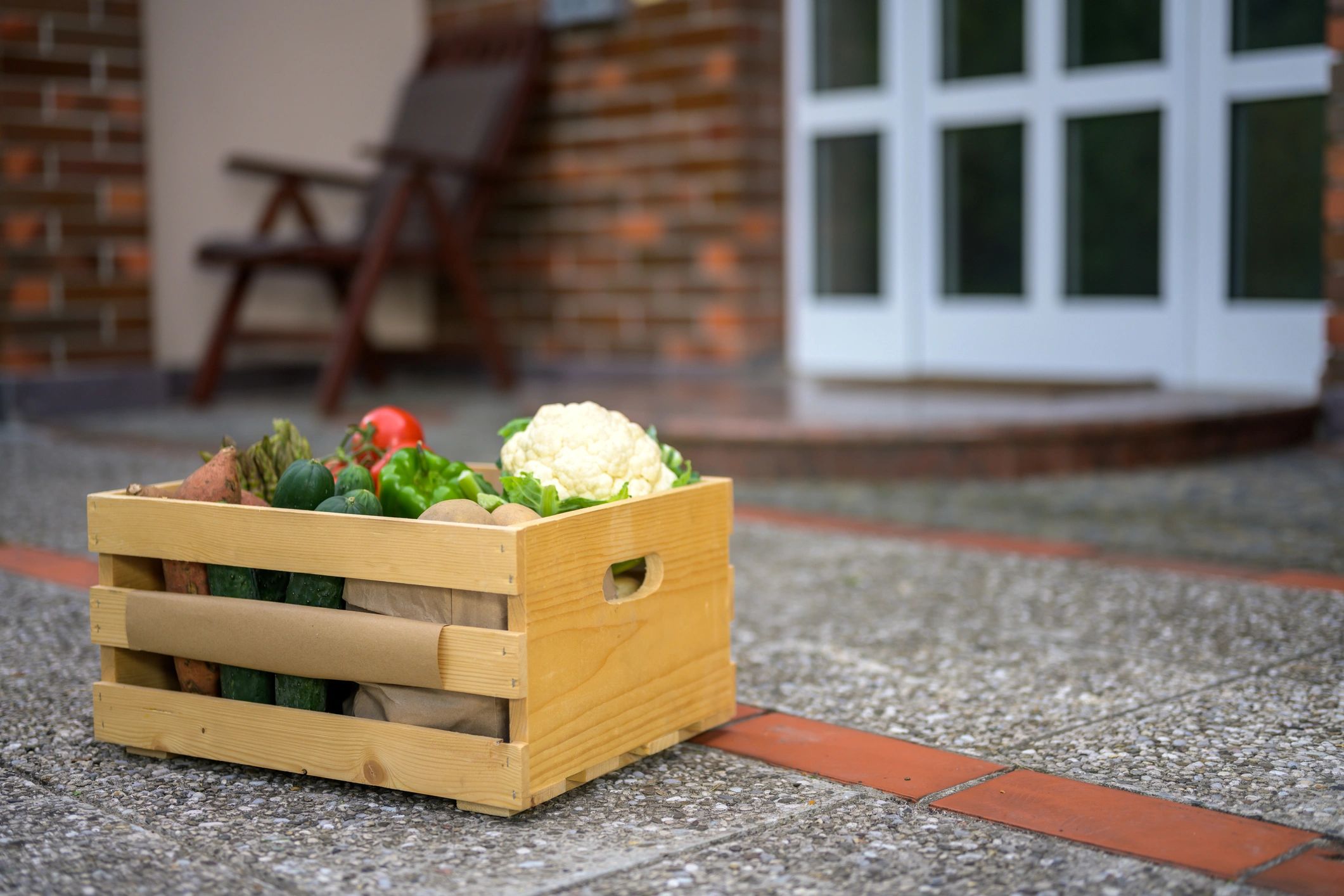 Crate of fresh vegetables prepared for doorstep delivery