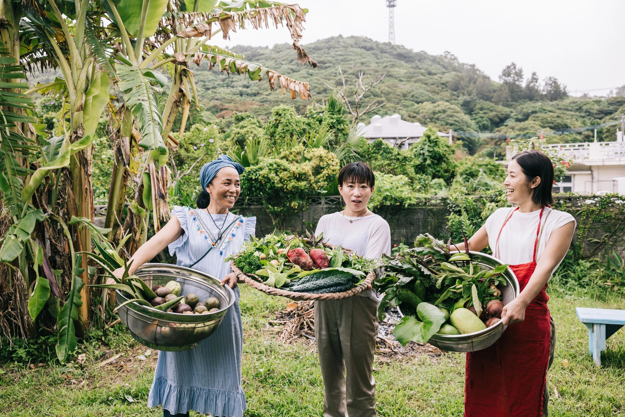 Smiling person holding a basket of vegetables